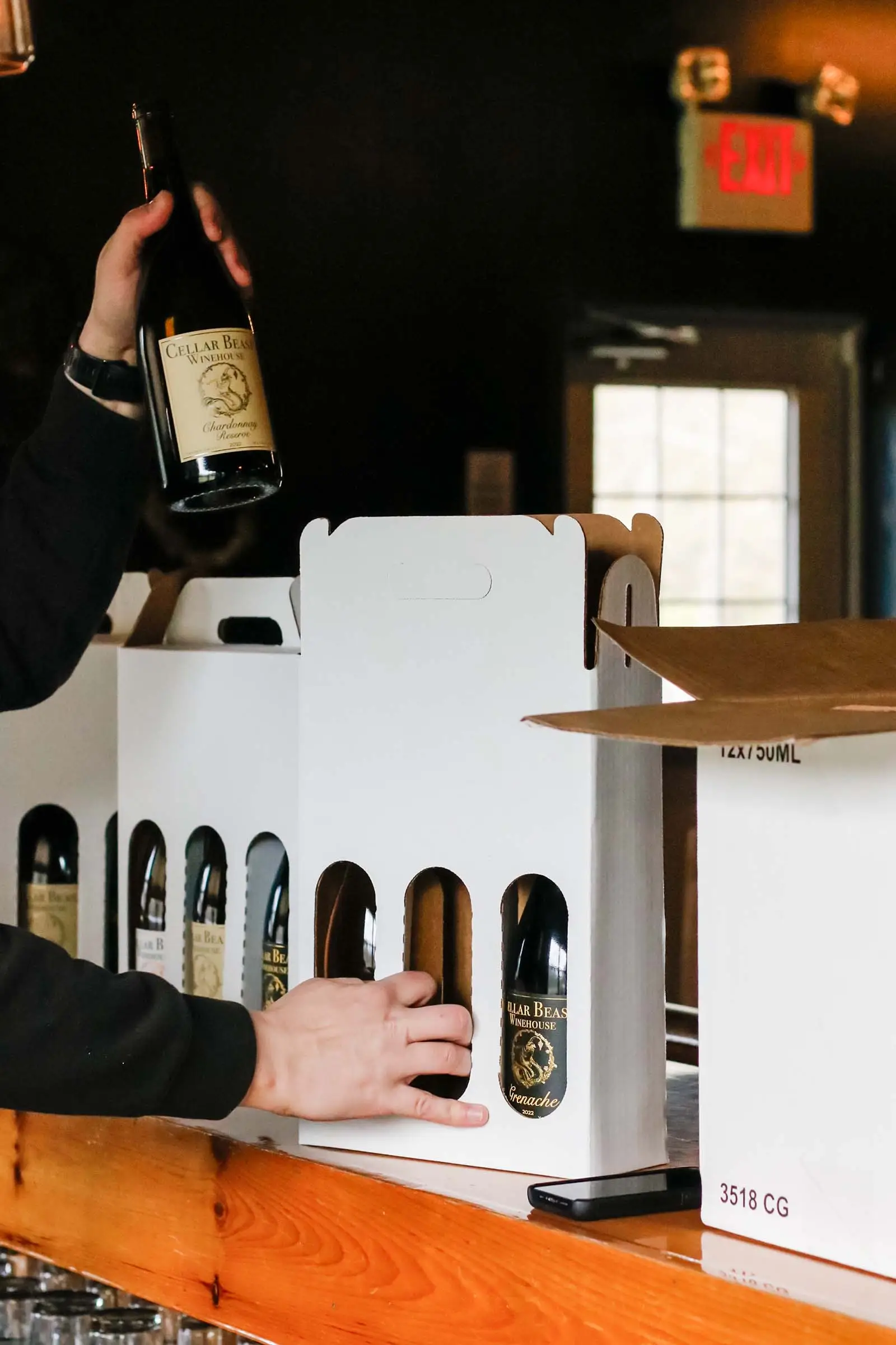 Cellar Beast bottles being packed into gift carriers