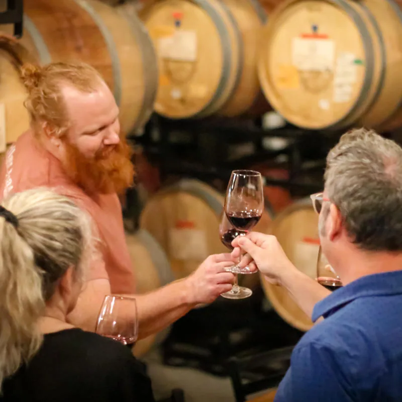 Guests raising glasses at a Cellar Beast barrel tasting